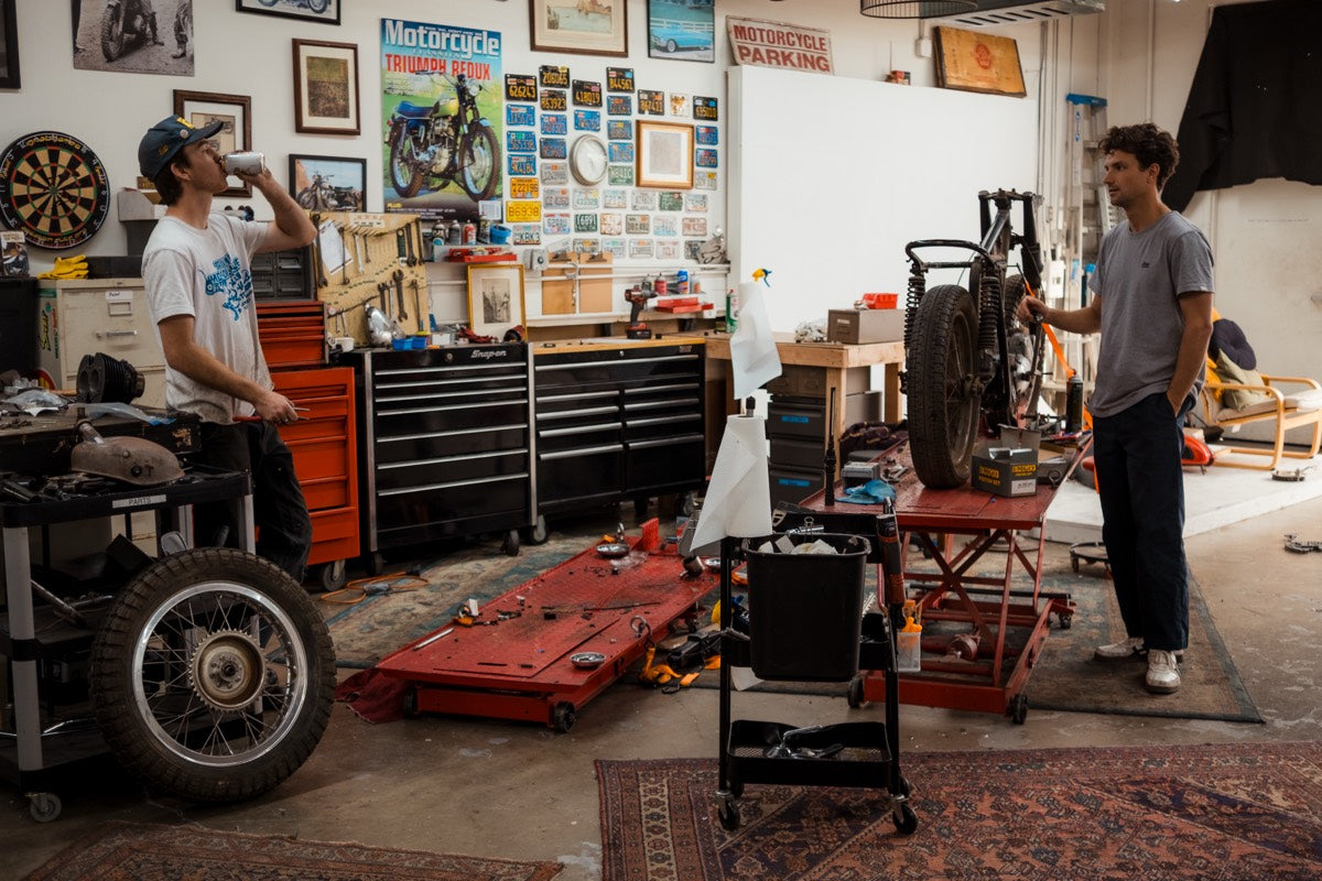 A Triumph on the lift at the Le Hangar 23 workshop